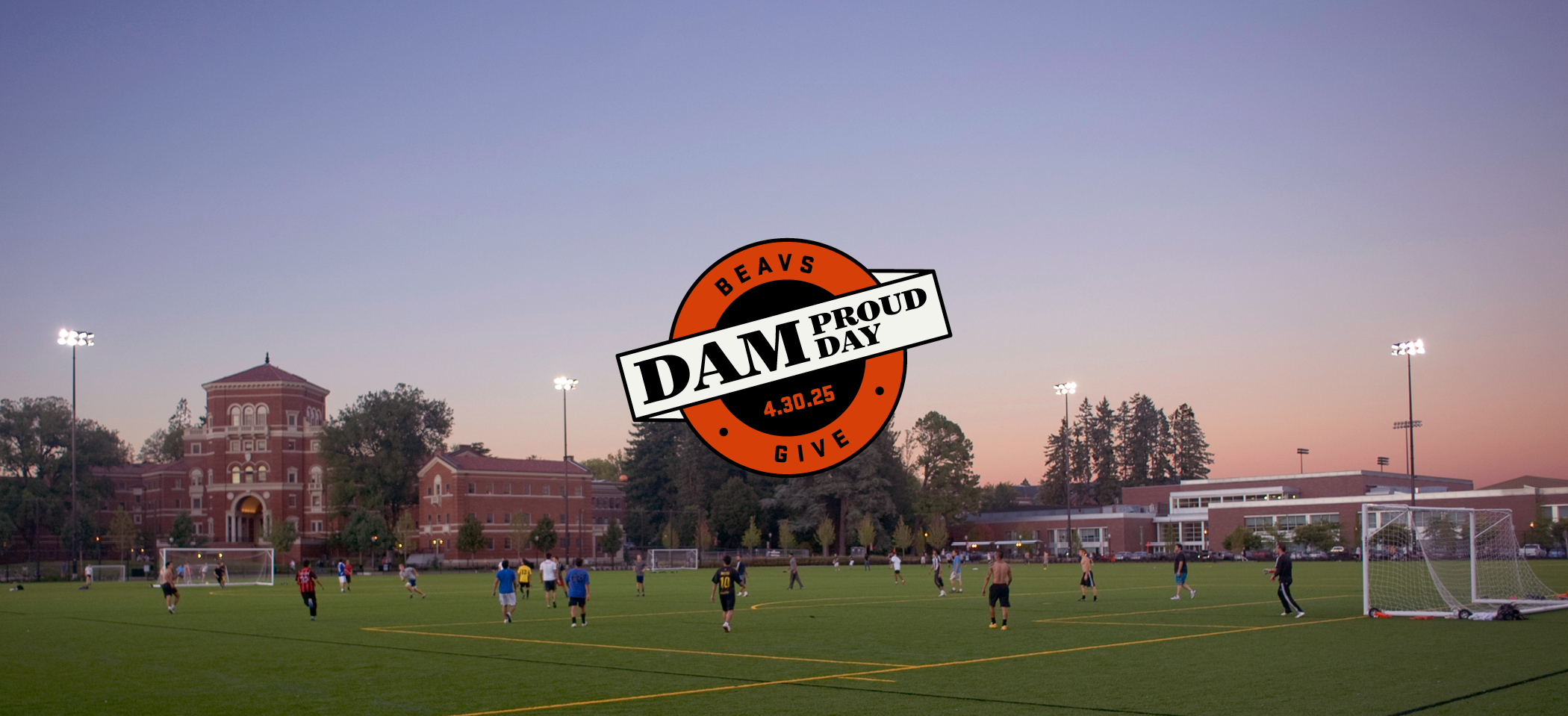Students play soccer in an outdoor field on campus.