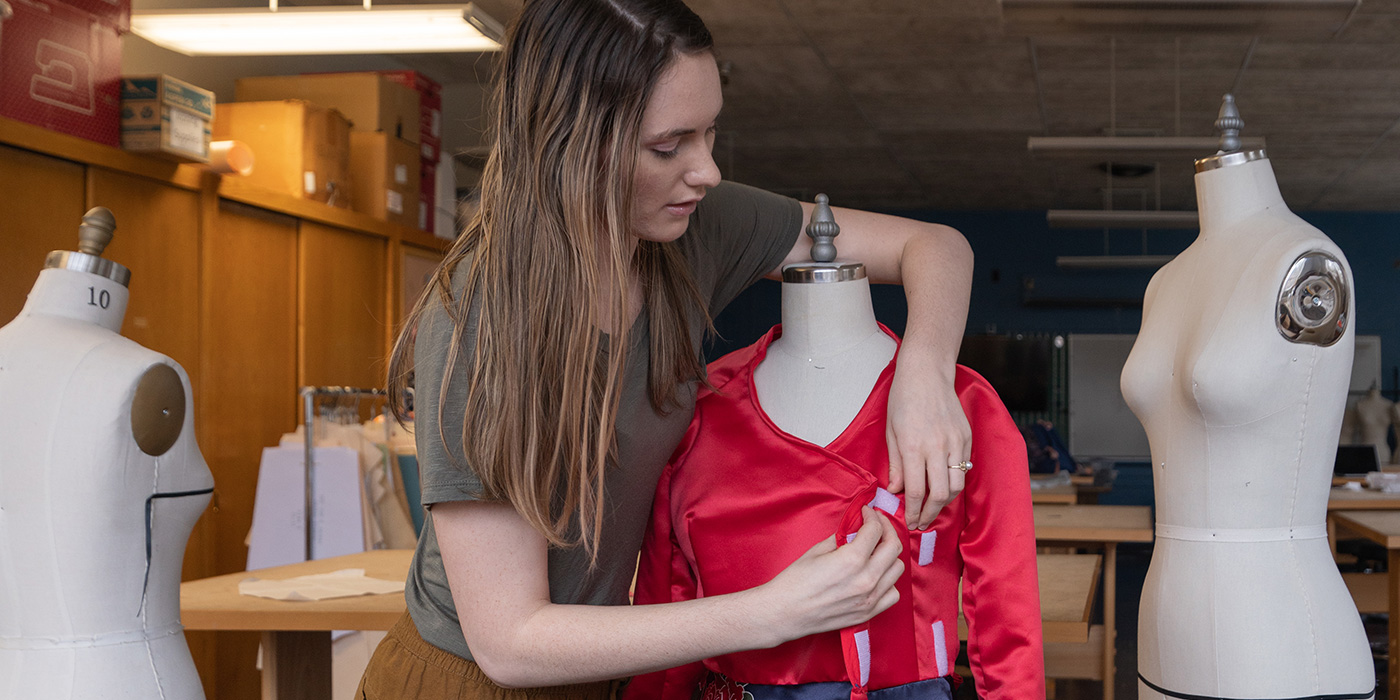 person sizing a garmet at a dress form