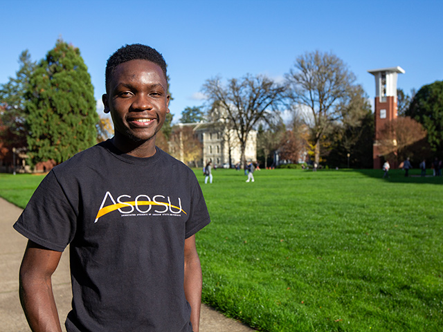 Omondi smiling while standing in the MU Quad