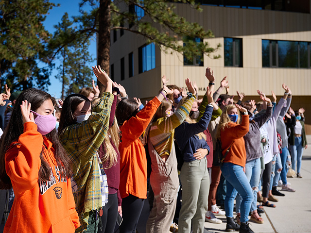 people standing in a line waving