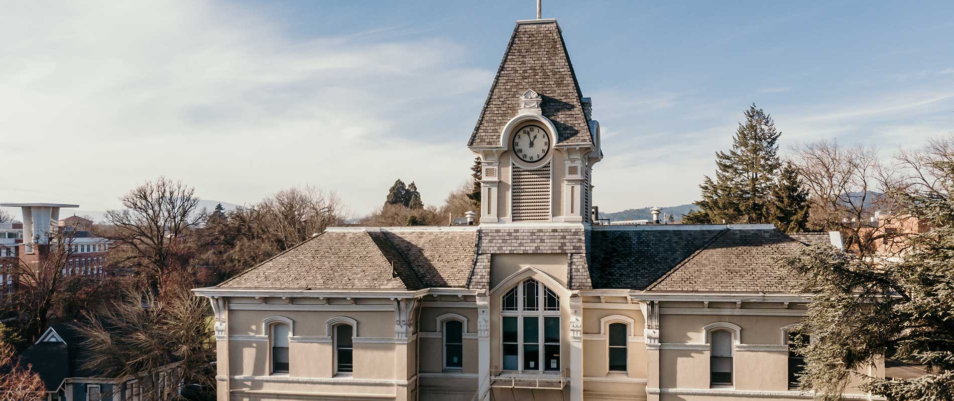 aerial view of Community Hall surrounded by bare trees and sunny skies