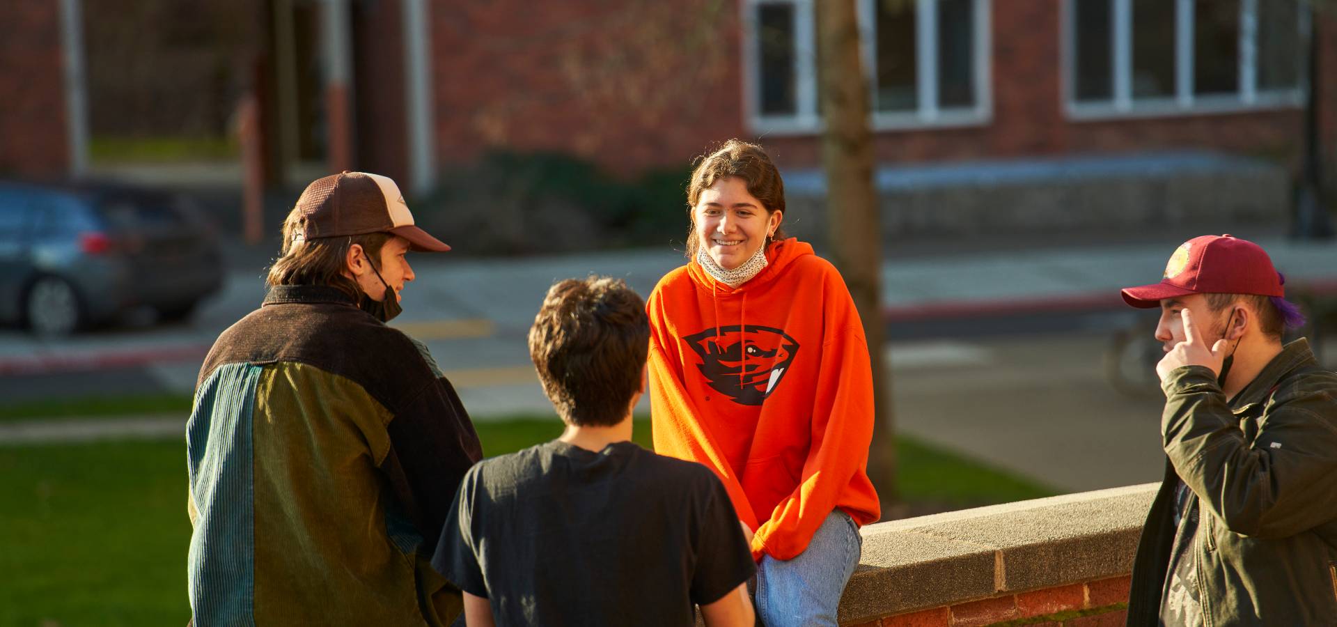 students socializing on a brick wall
