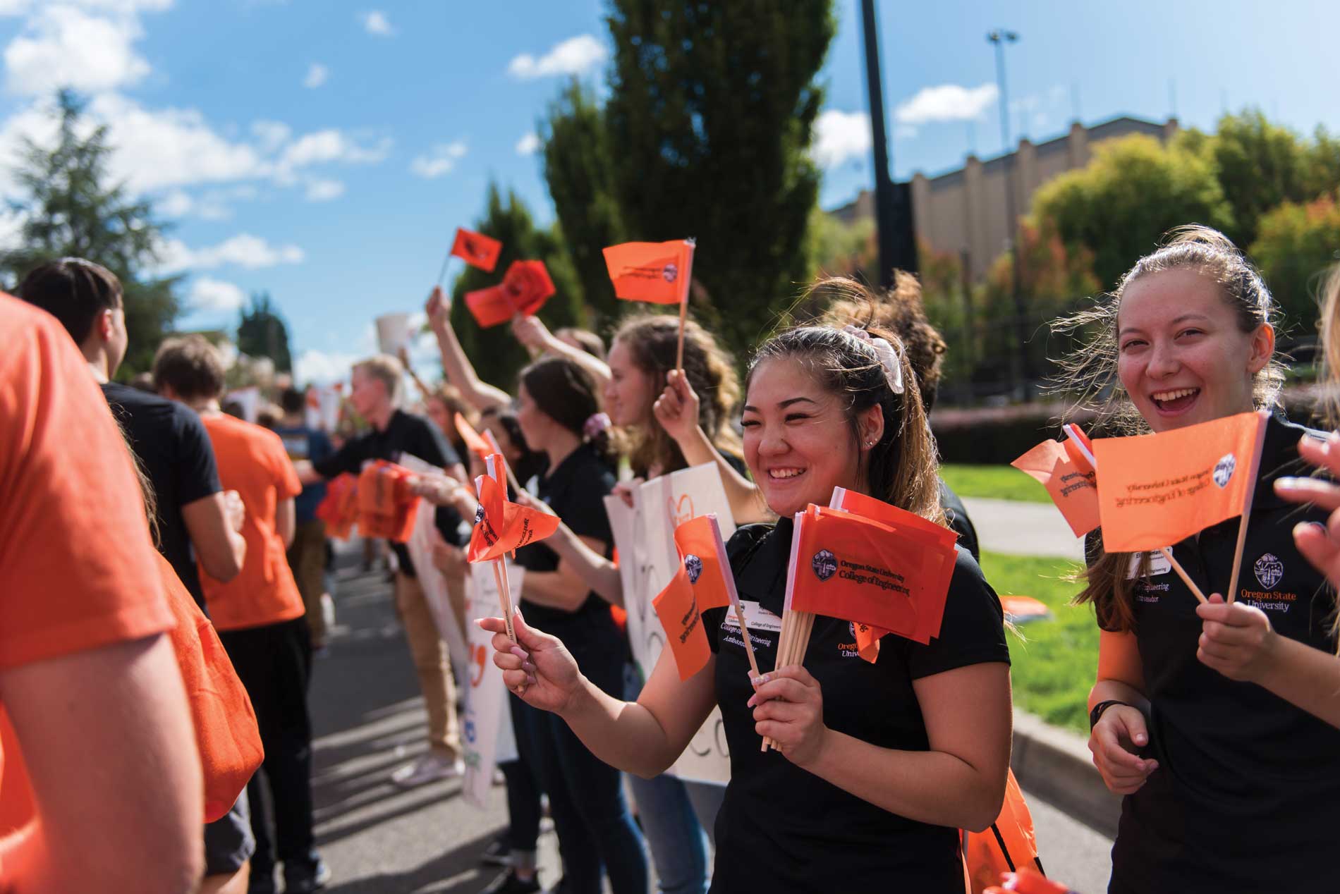 students waving OSU flags for convocation