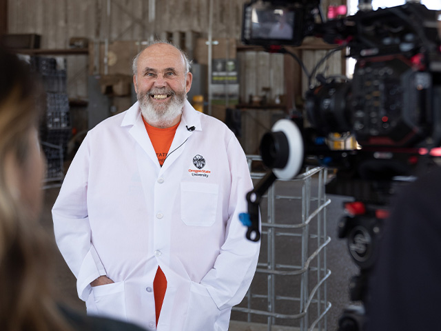 film crew filiming researcher in lab coat