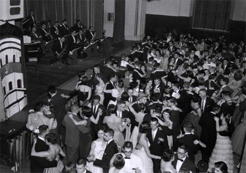 black and white photo of people dancing with an orchestra