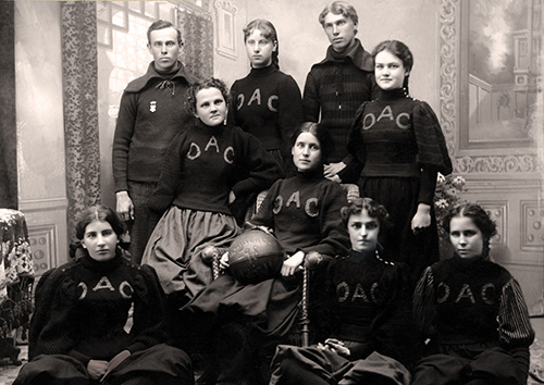black and white photo that shows a group of people OAC sweatshirts, one holding a basketball