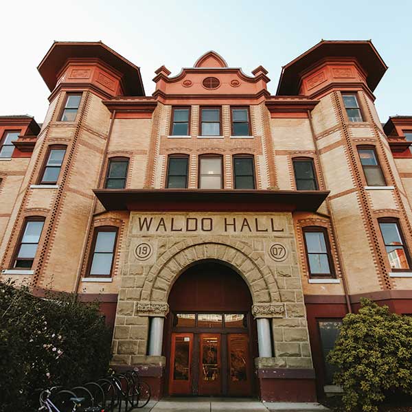 Waldo Hall, a tan brick building with red trim