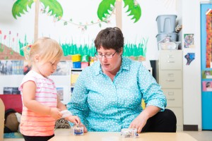 Faculty researcher and toddler in daycare interaction
