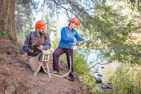faculty and student studying Metolius River ecosystem