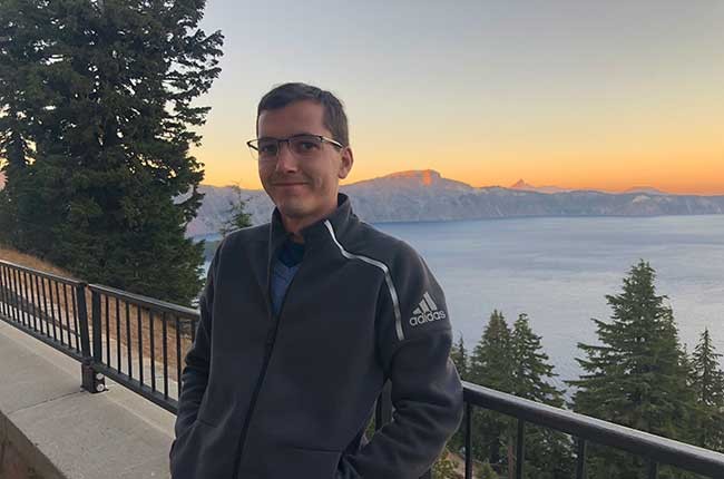 portrait of John Paul in front of scenic view